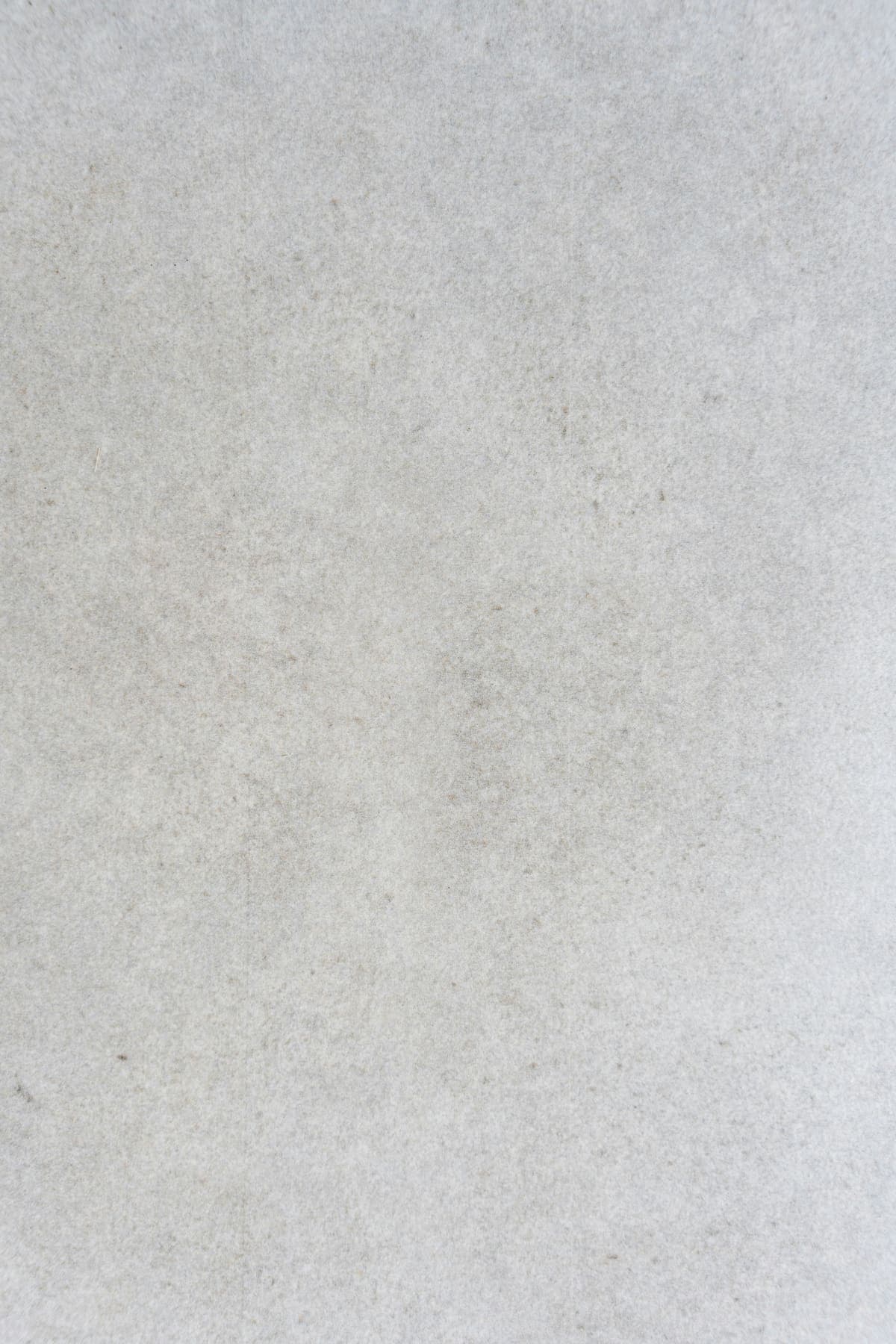 Pale honed Wiltshire limestone surface, raking afternoon light
